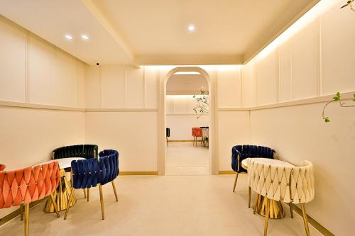 a room with chairs and a table and a hallway at Denbasta Hotel Daeyeon in Busan