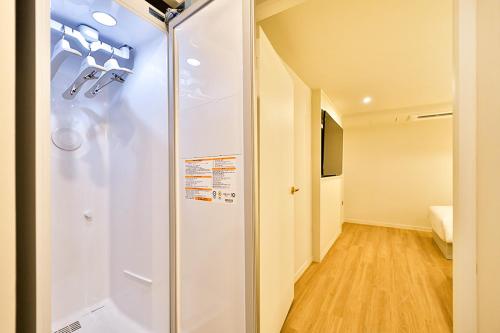 a bathroom with a shower in a room at Denbasta Hotel Daeyeon in Busan