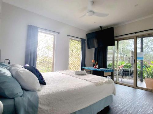 a bedroom with a large bed and a table at Beachside One Bedroom Flat Retreat in Maroochydore