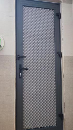 a door with a metal gate in a building at Nhà Nghỉ Xuân Lan in Can Tho