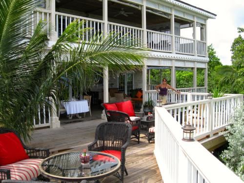 a woman standing on the porch of a house at A Stone's Throw Away in Nassau