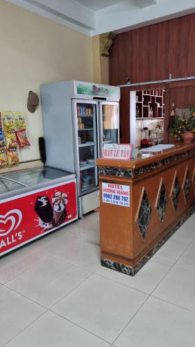 a restaurant with a counter and a refrigerator at Hương Giang Hotel & Coffee in Thái Bình