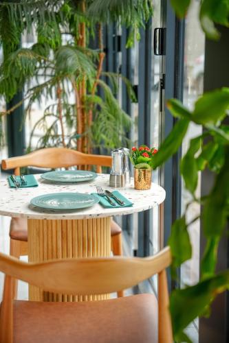a table with two chairs and a table with plates at Novotel Istanbul Bosphorus Hotel in Istanbul