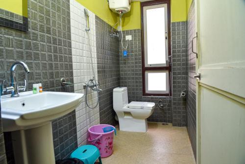 a bathroom with a sink and a toilet and a window at Rufina Lachung Heritage in Lachung
