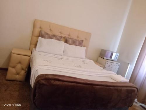 a bedroom with a large bed with white sheets and pillows at Bullez guest house in Mahikeng