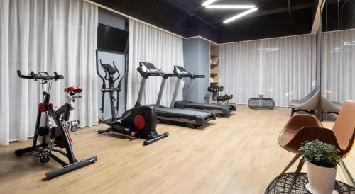 a gym with treadmills and exercise bikes in a room at Atour Hotel Heyuan Wanlong in Heyuan