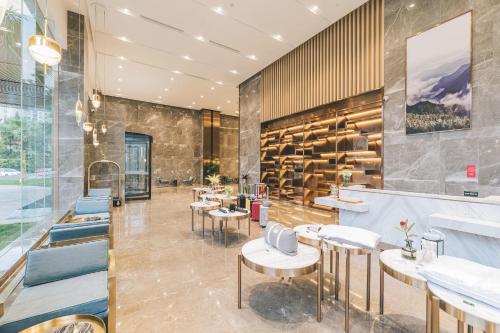 a restaurant with tables and chairs in a room at Atour Hotel Ningbo Airport Yinzhou Avenue in Ningbo