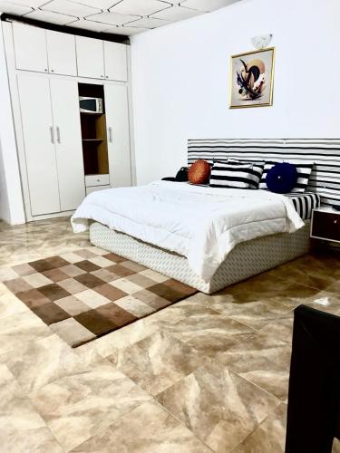 a bedroom with a bed and a checkered floor at APARTMENT 30A in Abuja