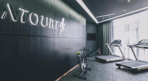 a gym with a bike and cardio equipment on the wall at Atour Hotel Ningbo Airport Yinzhou Avenue in Ningbo