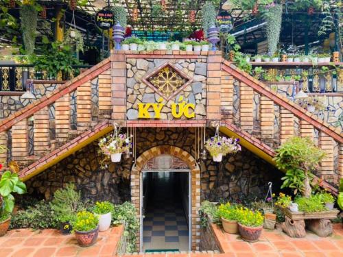 a small brick building with a staircase and plants at Memory Villa in Da Lat