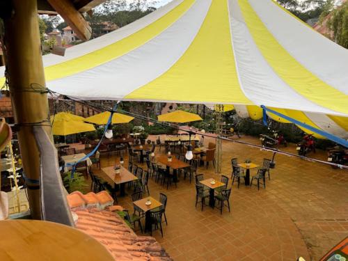 an overhead view of a restaurant with tables and yellow umbrellas at Memory Villa in Da Lat