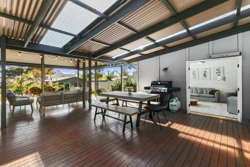 a large living room with a table and a couch at Christies Garden - A Beachside Entertainer's Gem in Adelaide