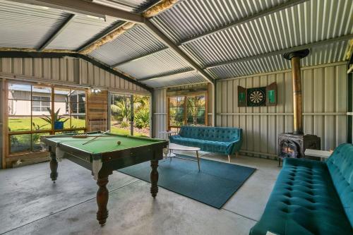 a living room with a pool table and a fireplace at Christies Garden - A Beachside Entertainer's Gem in Adelaide