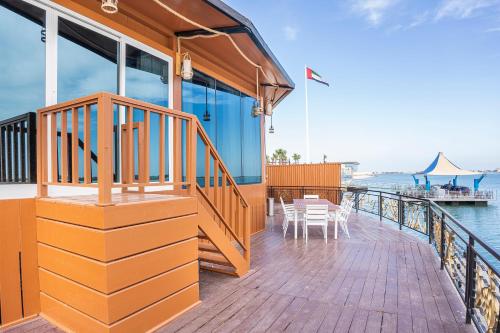 a deck on a cruise ship with tables and chairs at Palma Beach Resort & Spa in Umm Al Quwain