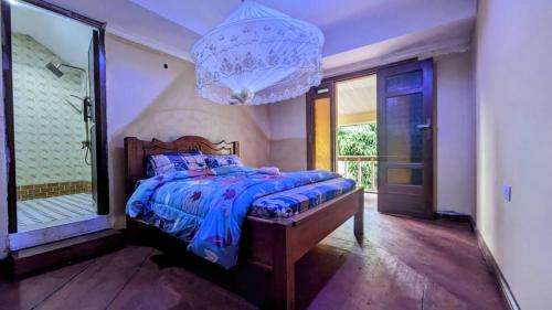 a bedroom with a large bed and a large mirror at MICHELLE HOME STAY in Hambayo