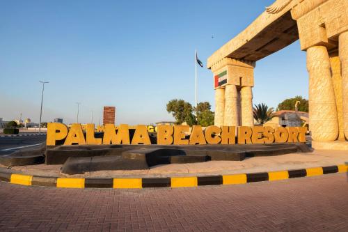 a sign that reads palma beach resort on a street at Palma Beach Resort & Spa in Umm Al Quwain