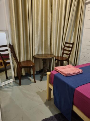 a room with a table and chairs and curtains at River Front Villa in Wadduwa