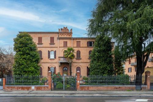 a large brick building with a fence in front of it at Azzurra1 in Bologna