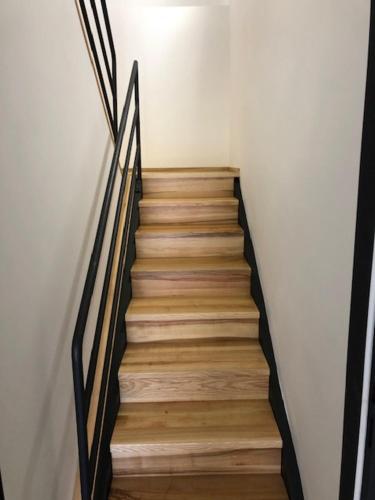 a staircase with wooden floors and a white wall at UBYTOVNA SK Posázavan Poříčí nad Sázavou in Poříčí nad Sázavou