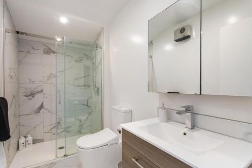 a bathroom with a shower and a sink and a toilet at Penthouse Apartment Scenic Views-Spacious 2br in Christchurch