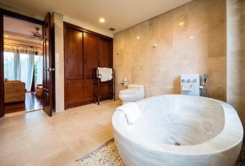 a large bathroom with a large tub in a room at 3BR garden pool villas in beach resort in Da Nang