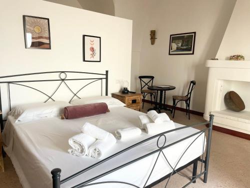 a bedroom with a bed with white towels on it at Masseria Vico in Villaggio Resta