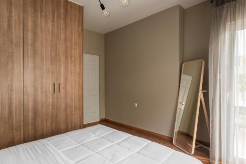 a bedroom with a bed and a closet at The Gate by Zoia Living in Athens