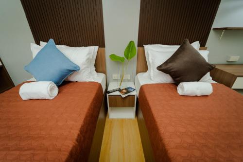 two beds sitting next to each other in a room at Balay Talisay 