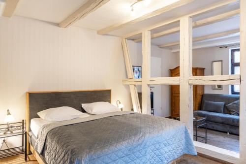 a bedroom with a loft bed and a couch at Schlossberg-Hotel Garni in Wernigerode