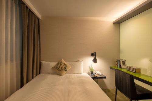 Postel nebo postele na pokoji v ubytování Finders Hotel-Fu Qian