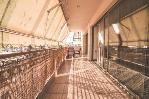 an empty hallway of a building with glass windows at Lazarus 2BD Apartment in the Center in Patra