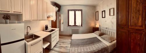 a kitchen with a bed in the middle of a room at La Bella Vigna in Marano di Valpolicella