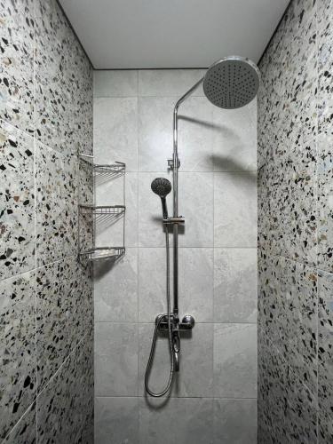 una doccia con soffione in un bagno di РОЙ a Almaty