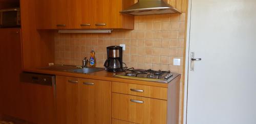 a kitchen with a sink and a coffee maker on the counter at La Pause Aigoual in Valleraugue