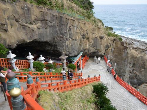 a cave on the side of a cliff next to the ocean at HOTEL MYSTAYS Miyazaki in Miyazaki