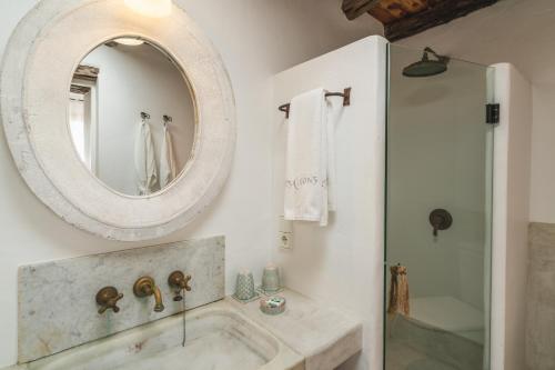 a bathroom with a sink and a mirror at ES CUCONS RURAL HOTEL in San Antonio