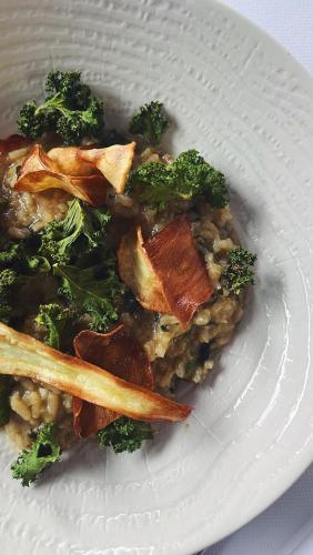a white plate of food with broccoli on a table at Logis Hotel L'Embarcadère in Nantua