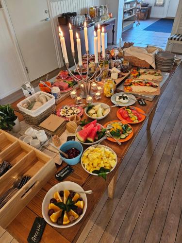 a long table filled with different types of food at Kaptenshuset Hotell in Kivik