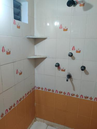 a shower with red and white tiles in a bathroom at Madhuban Homestay 1 Ujjain in Ujjain