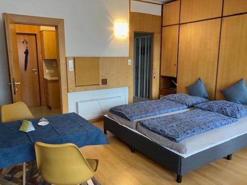 una camera con letto, tavolo e sedia di Appartamento Indaco Armonya a Merano