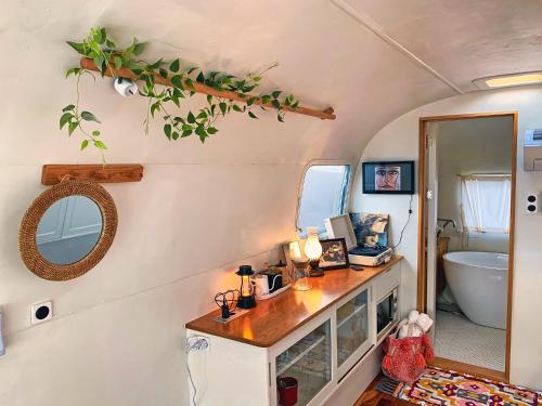 a bathroom with a vanity and a sink and a tub at BeachBoys - Retro Caravan AirStream in Jeju