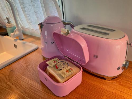 a pink hello kitty toaster sitting on a counter at BeachBoys - Retro Caravan AirStream in Jeju
