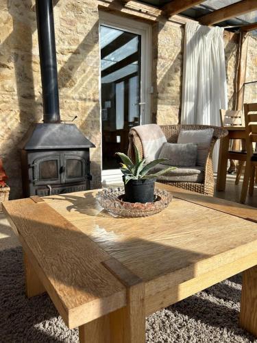 a wooden coffee table in front of a fireplace at The Old Lookout in Osmington