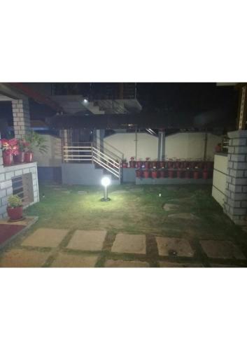 an empty room with a light in the middle of it at Sriniketana Homestay in Madikeri
