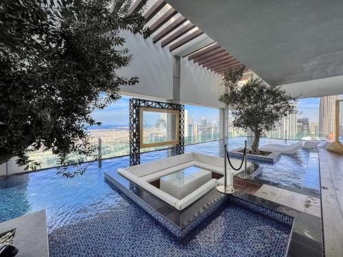 a swimming pool with a table in a building at Paramount Residences Dubai Apartments by BergStays in Dubai