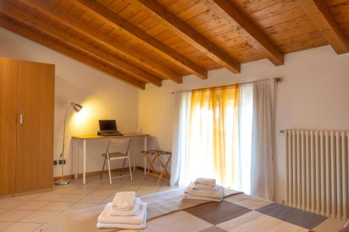a room with a bed with towels on the floor at Incantevole Mansardato 75mq vicino a BGY in Zanica