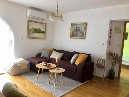 a living room with a couch and a table at Sokograd Attic in Šipovo