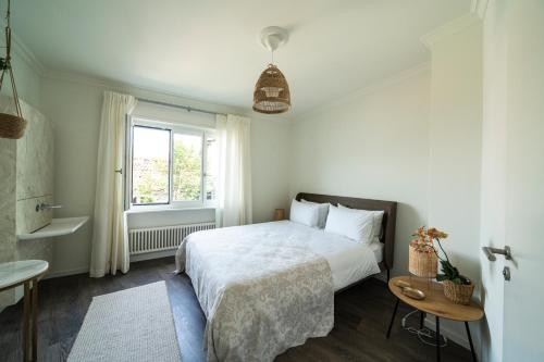 a bedroom with a white bed and a window at Villa Sophia in Gerra