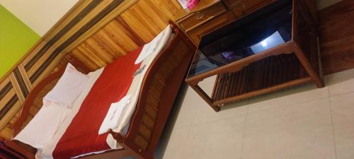 Litera de madera en una habitación en FLGHR Pc Residency, en Kodaikanal