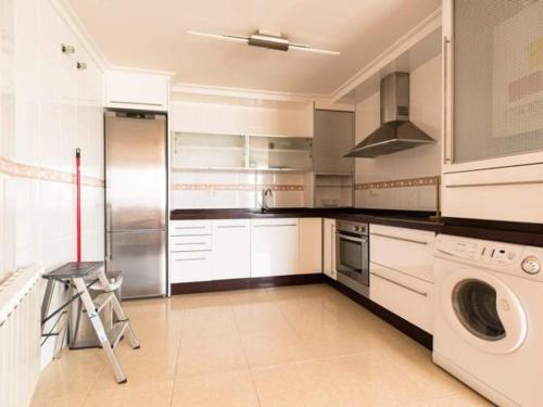 a kitchen with a washing machine and a washer at Reade homes in Luton